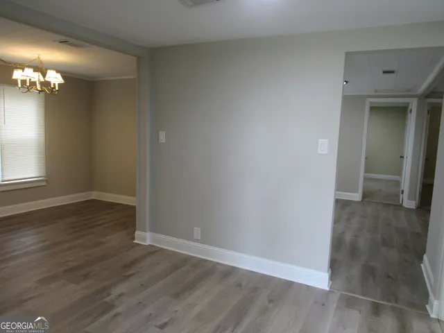 a kitchen with sink a microwave and cabinets