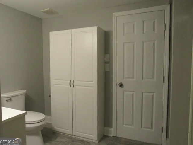 a bathroom with a sink toilet and vanity