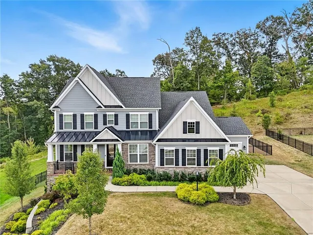 a front view of a house with a garden