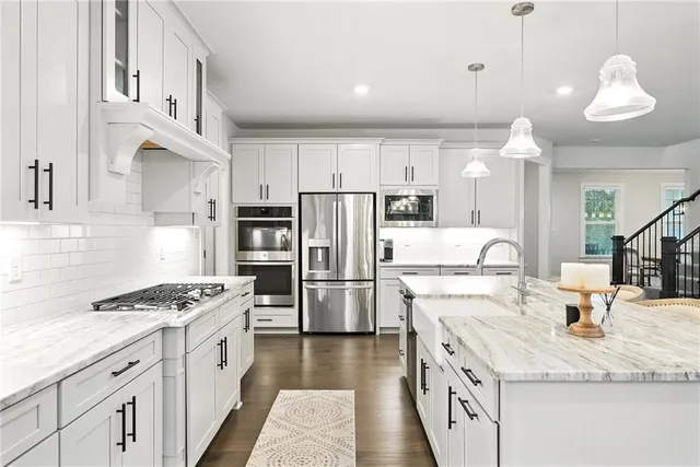 a kitchen with a sink stove and refrigerator