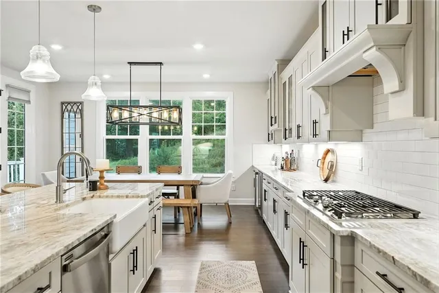 a large kitchen with stainless steel appliances granite countertop a stove and a sink