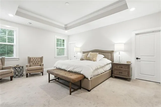 a spacious bedroom with a bed and furniture