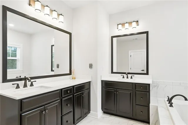 a bathroom with a double vanity sink mirror and