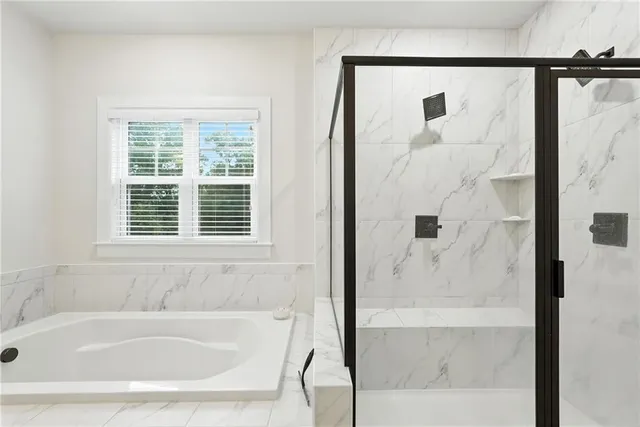 a white bath tub sitting next to a shower