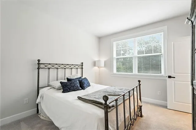 a bed sitting in a bedroom next to a window