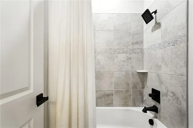 a bathroom with a shower and a sink