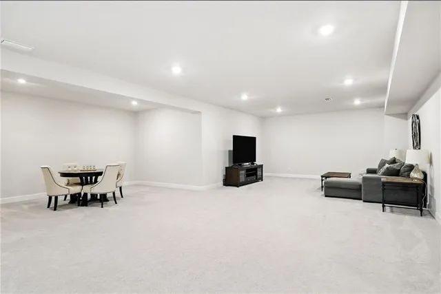 a view of a livingroom with furniture and a flat screen tv