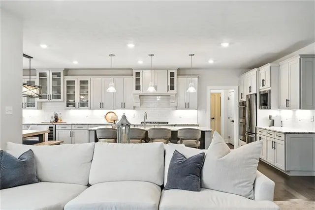 a living room with furniture and kitchen view