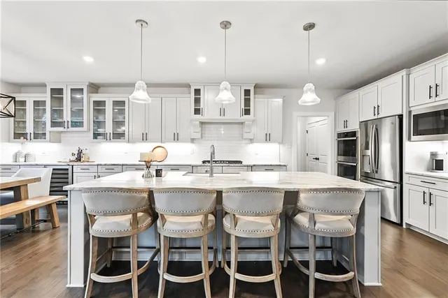 a large kitchen with a table and chairs
