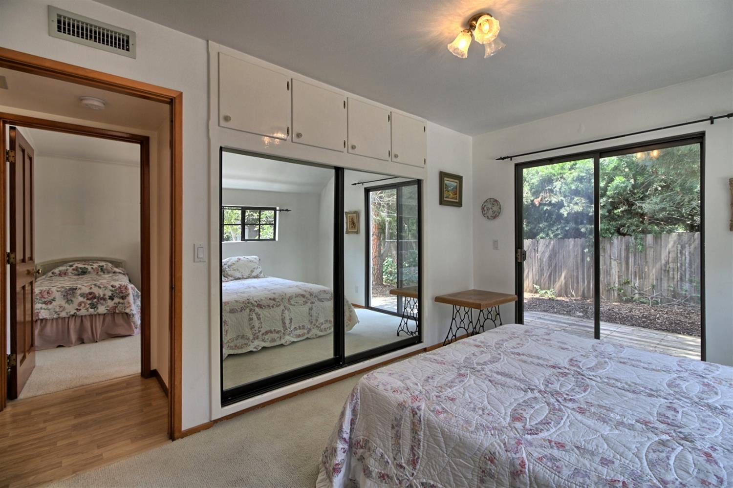 205 Palomar Road Ojai, CA 93023 - Photo 28 of 38 a bedroom with a bed and a chandelier