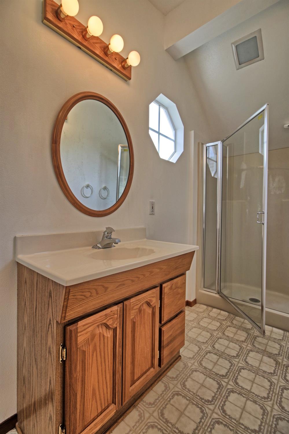 205 Palomar Road Ojai, CA 93023 - Photo 35 of 38 a bathroom with a sink a mirror and a shower