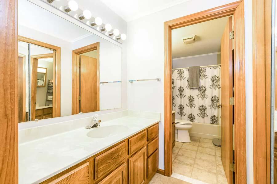 174 Lowell Road, Unit J117 Mashpee, MA 02649 - Photo 17 of 26 a bathroom with a sink a toilet and shower