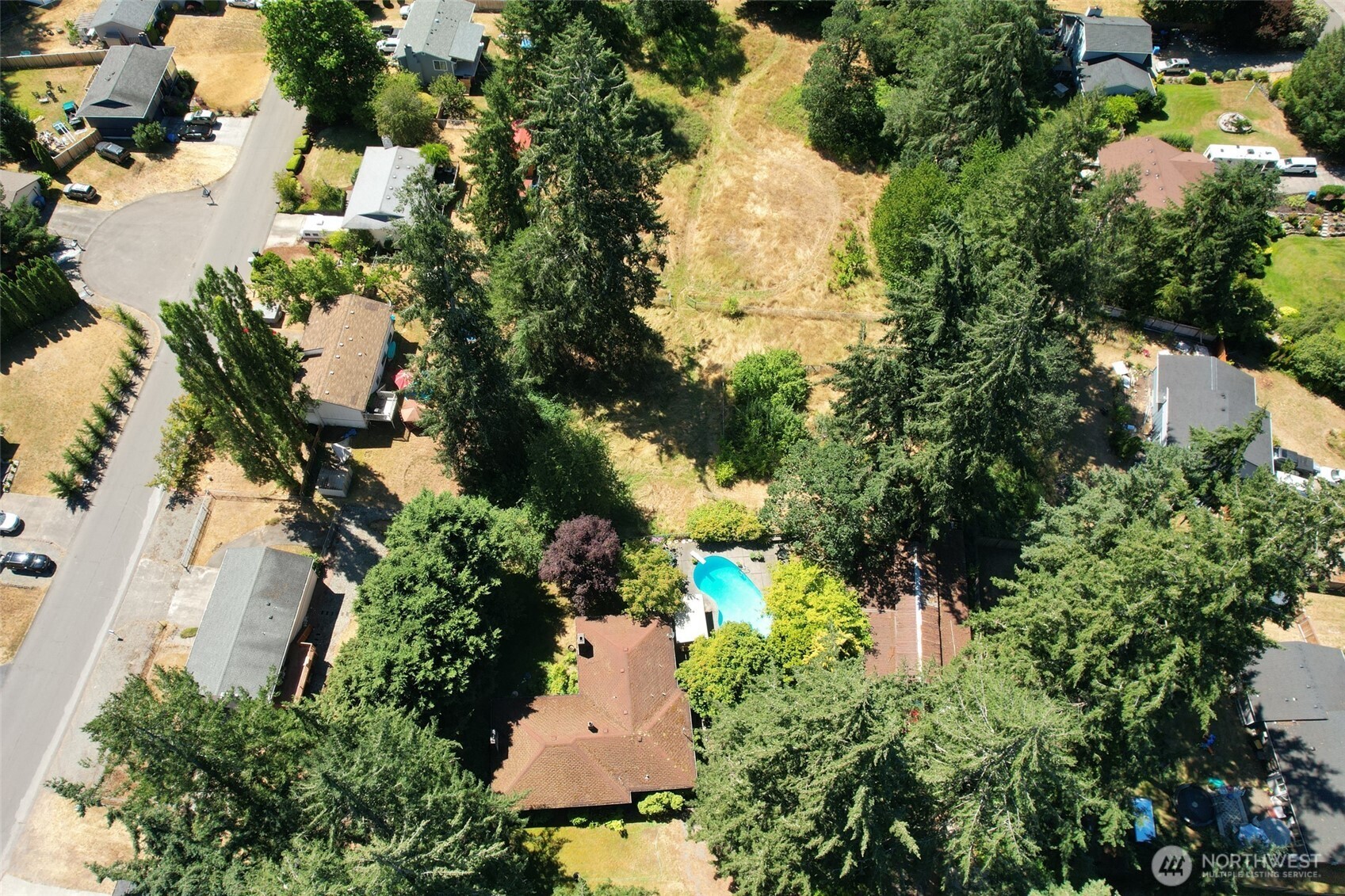 an aerial view of a house with a yard and lake view