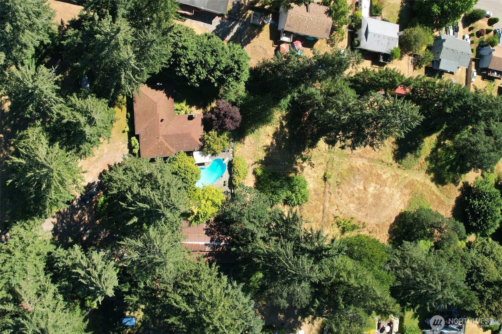 16006 Spanaway Loop Road South Spanaway, WA 98387 - Photo 5 of 8 an aerial view of a house with a yard and trees all around