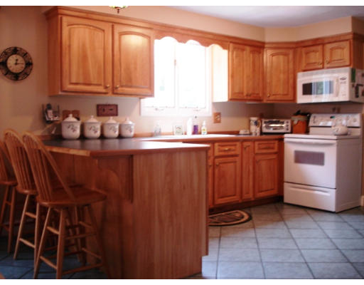 57 Holden Road Shirley, MA 01464 - Photo 3 of 18 a kitchen with stainless steel appliances granite countertop a sink stove and cabinets