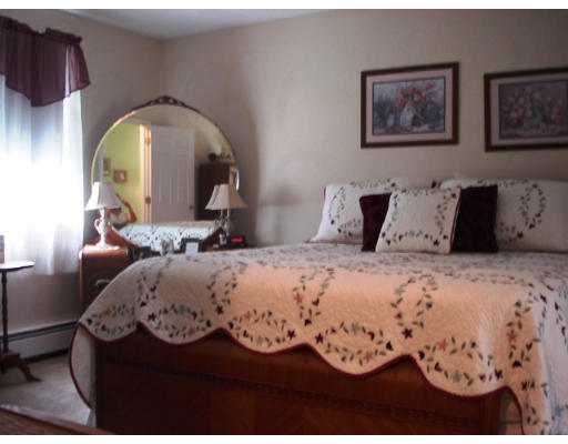 57 Holden Road Shirley, MA 01464 - Photo 9 of 18 a bedroom with a bed and a painting on the wall