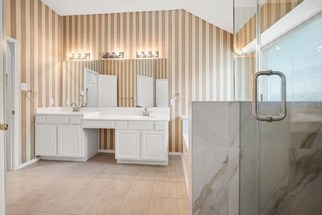 a bathroom with a tub shower and sink