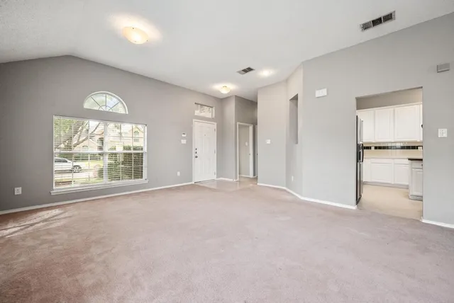 a view of an empty room with a window