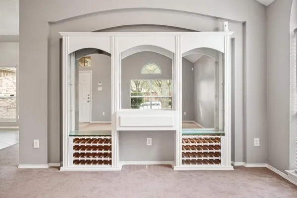 wooden floor fireplace and windows in an empty room