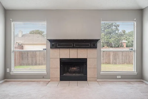 a view of a livingroom with a fireplace and a window