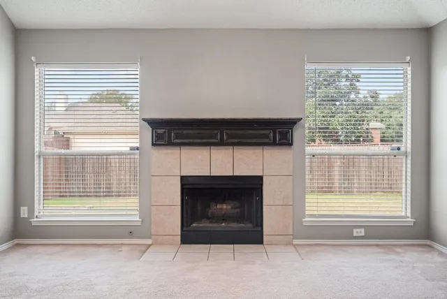 a view of a livingroom with a fireplace and a window