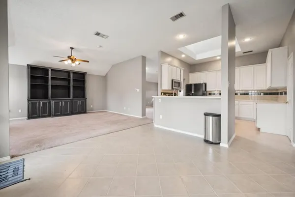 a kitchen with granite countertop white cabinets and stainless steel appliances