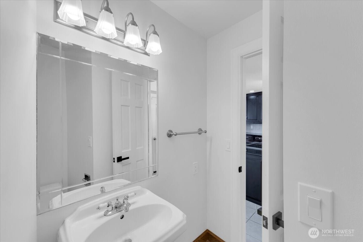 16015 Inglewood Road Northeast Kenmore, WA 98028 - Photo 11 of 37 a bathroom with a sink and a mirror