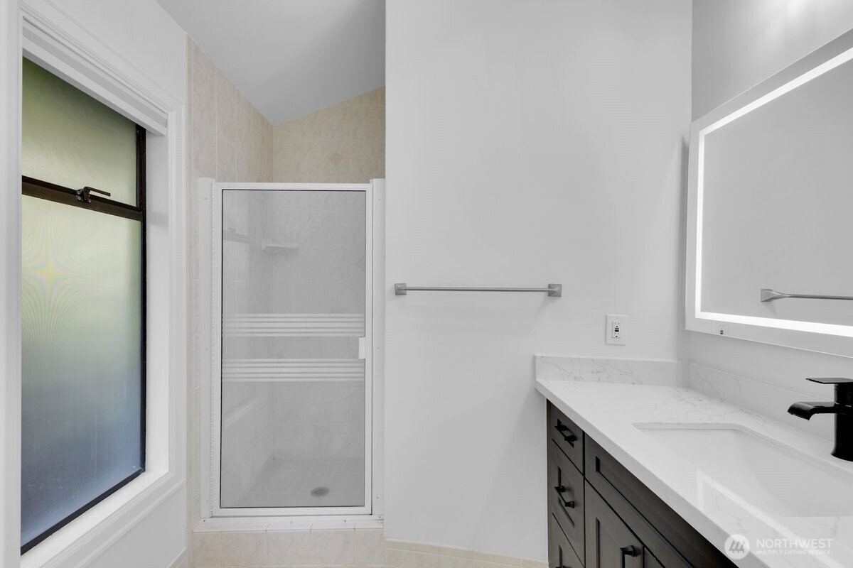 16015 Inglewood Road Northeast Kenmore, WA 98028 - Photo 16 of 37 a bathroom with a sink a toilet and shower