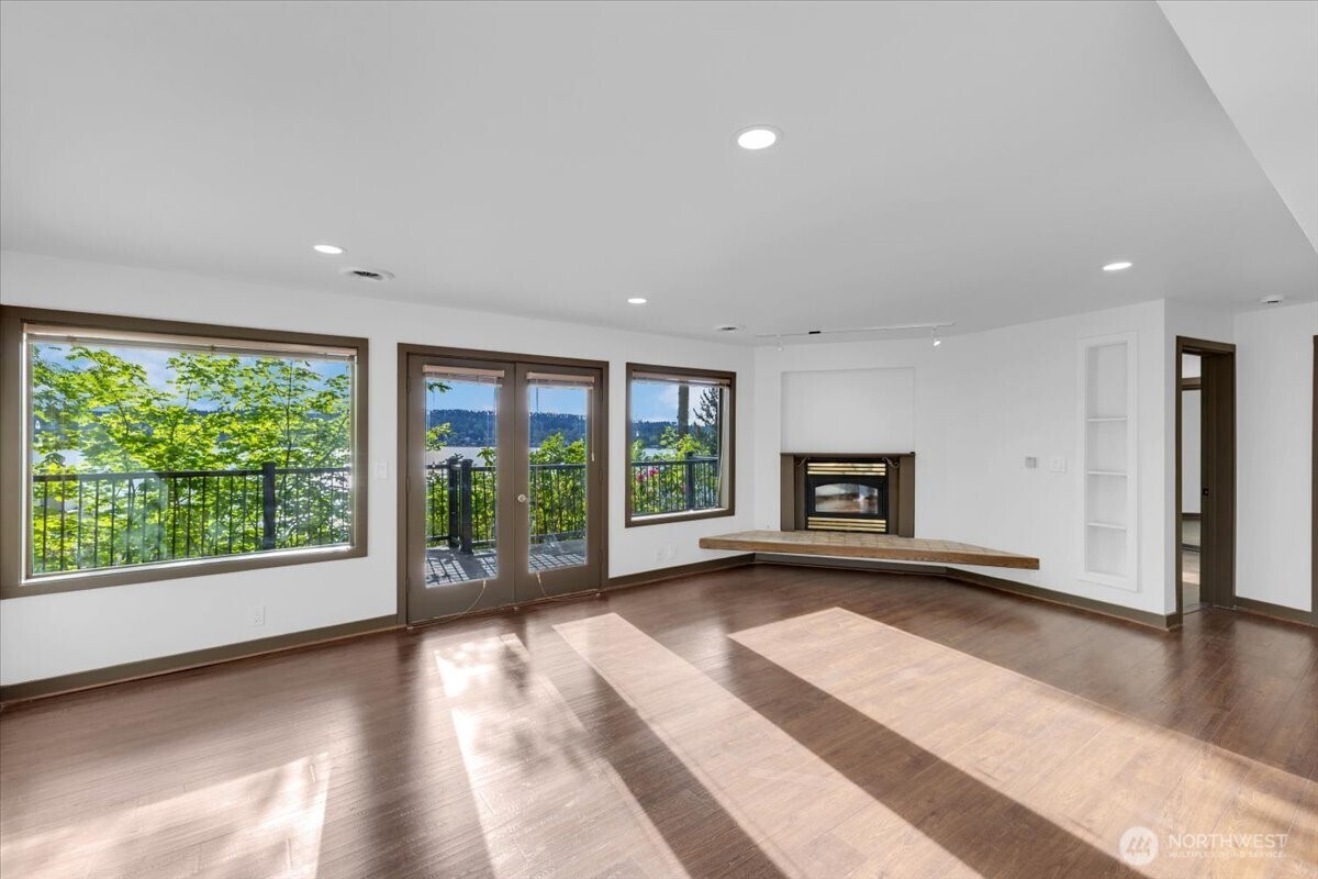 16015 Inglewood Road Northeast Kenmore, WA 98028 - Photo 26 of 37 a view of an empty room with a window and wooden floor