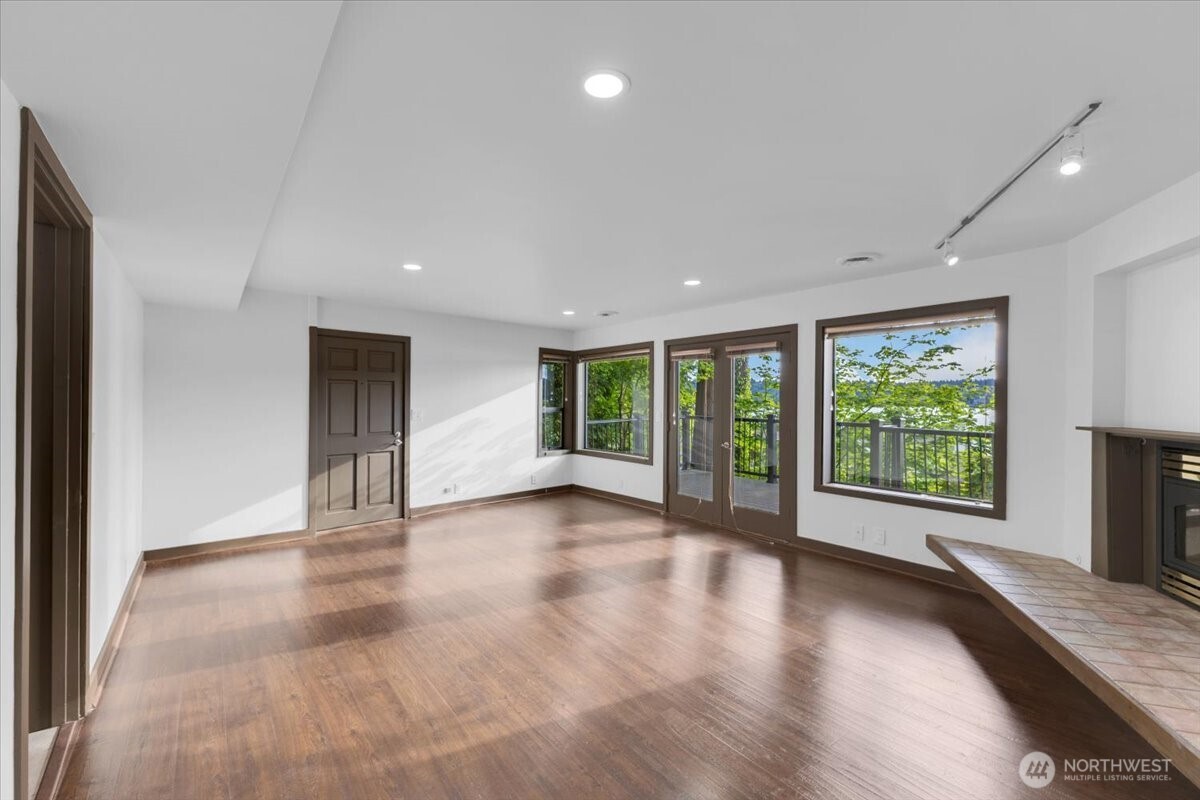 16015 Inglewood Road Northeast Kenmore, WA 98028 - Photo 27 of 37 a view of an empty room with wooden floor and a window