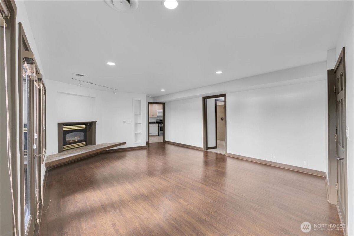 16015 Inglewood Road Northeast Kenmore, WA 98028 - Photo 28 of 37 a view of an empty room with a window and wooden floor