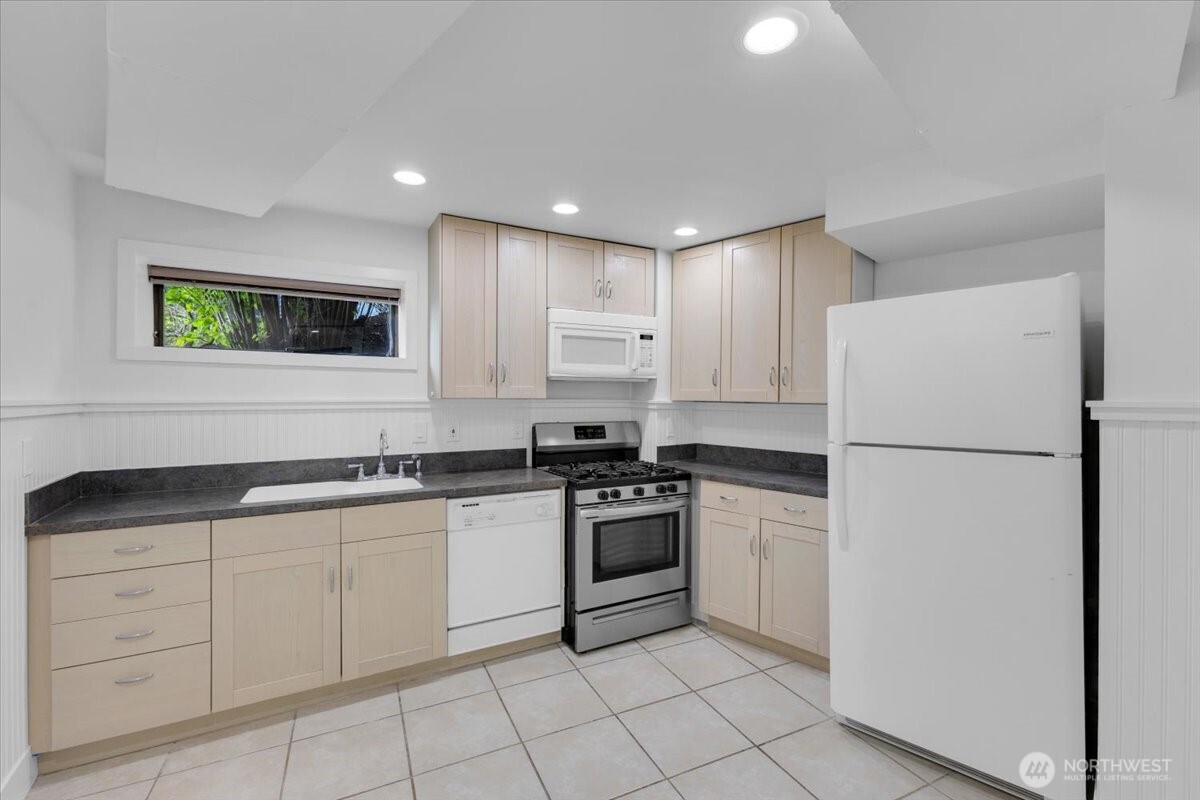 16015 Inglewood Road Northeast Kenmore, WA 98028 - Photo 29 of 37 a kitchen with white cabinets and white appliances