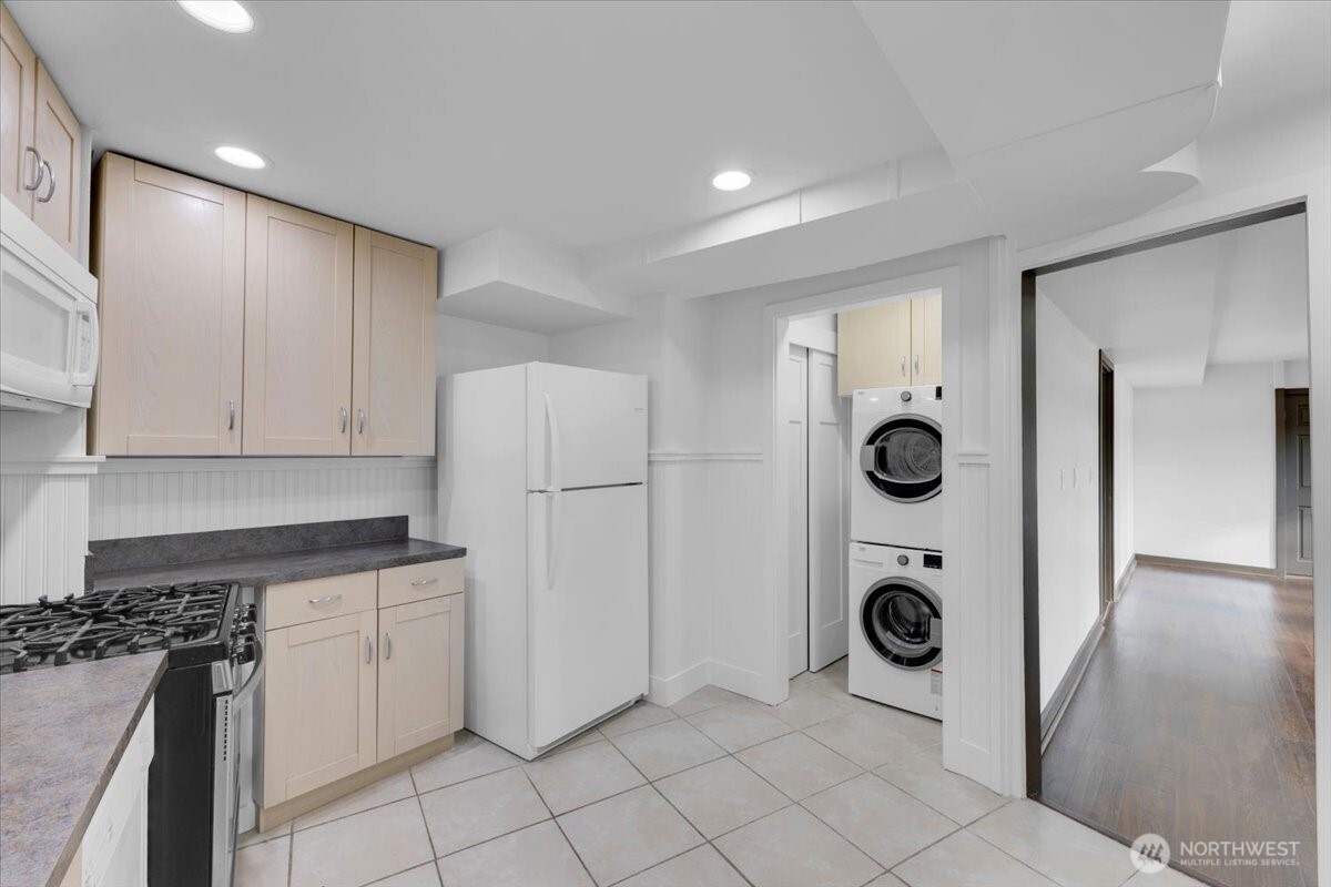 16015 Inglewood Road Northeast Kenmore, WA 98028 - Photo 30 of 37 a kitchen with a refrigerator and a stove top oven