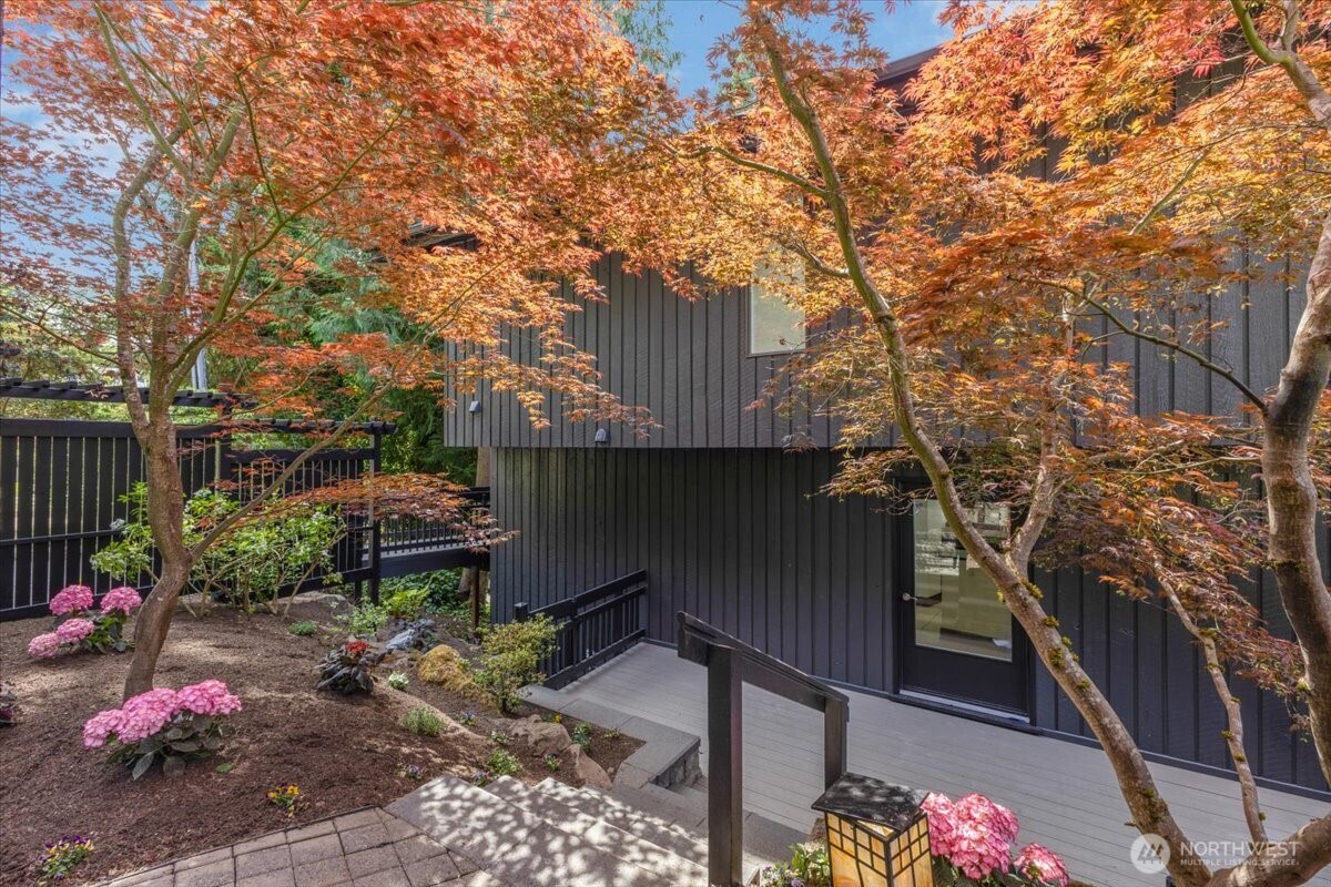 16015 Inglewood Road Northeast Kenmore, WA 98028 - Photo 6 of 37 a backyard of a house with table and chairs