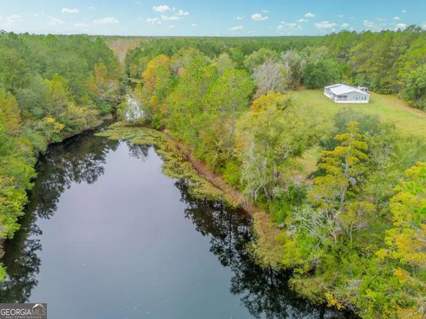 a kitchen with stainless steel appliances kitchen island granite countertop a refrigerator a stove and a wooden cabinets