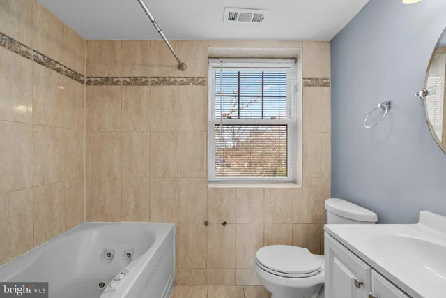 a bathroom with a toilet and a bathtub