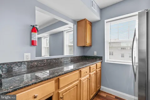 a view of a kitchen sink cabinets and microwave