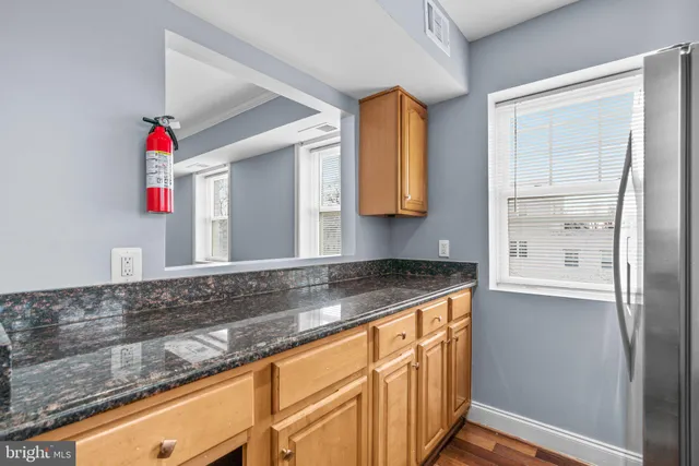 a view of a kitchen sink cabinets and microwave