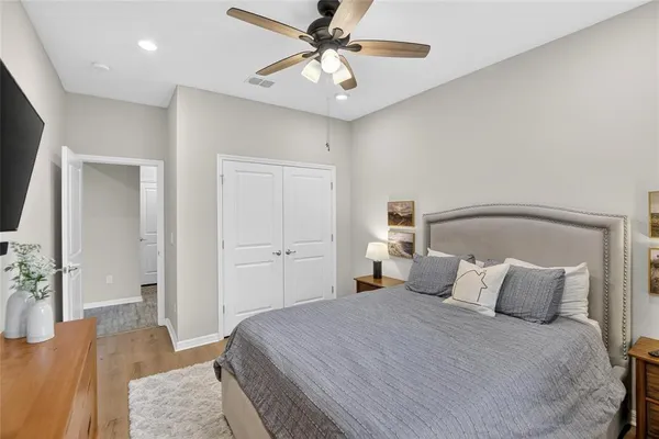 a view of room with flat screen tv on dresser and a chandelier