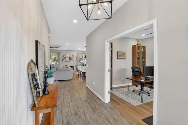 a kitchen with stainless steel appliances kitchen island granite countertop a stove a sink a dining table and chairs with wooden floor