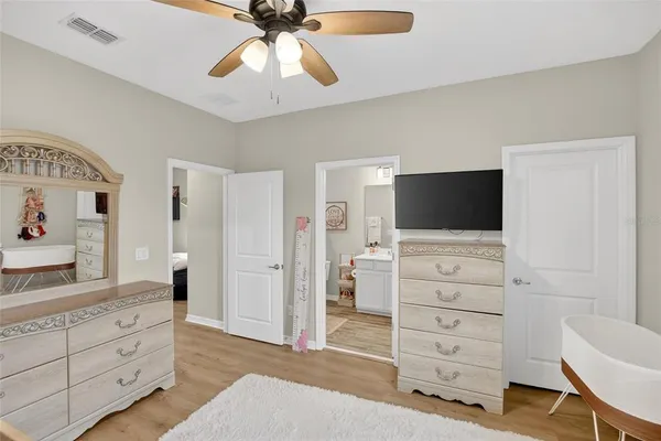 a bathroom with a double vanity sink toilet mirror and shower