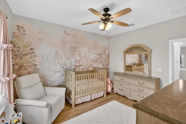 a bedroom with a bed window and a desk