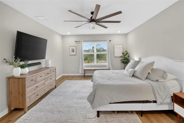 a view of white house with a big yard and palm trees