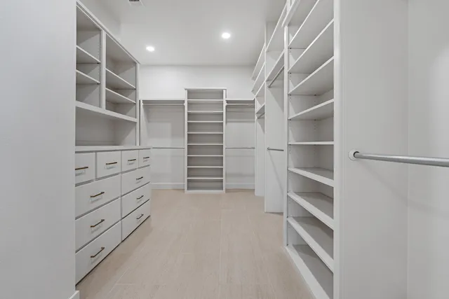 a bathroom with a granite countertop bathtub shower sink vanity and toilet