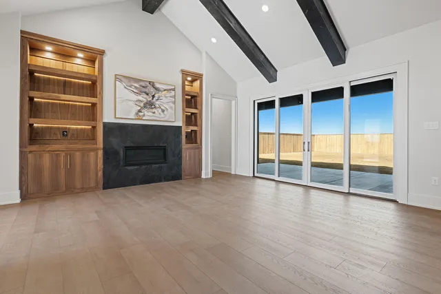 a large kitchen with a large counter top a sink a window and stainless steel appliances