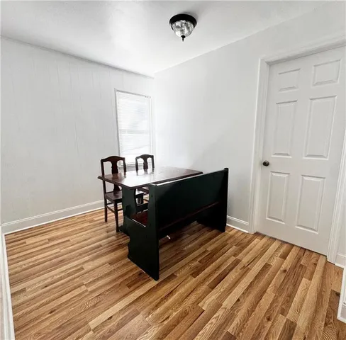 a room with wooden floor and furniture