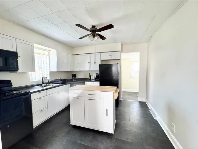 a kitchen with a stove a sink and a refrigerator