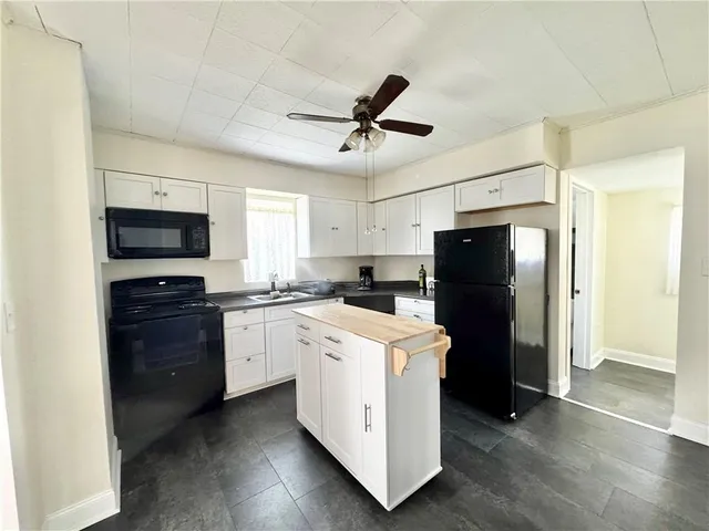a kitchen with a refrigerator stove and microwave