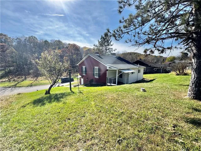 a house view with swimming pool and trees
