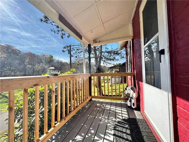 a view of a balcony with wooden floor